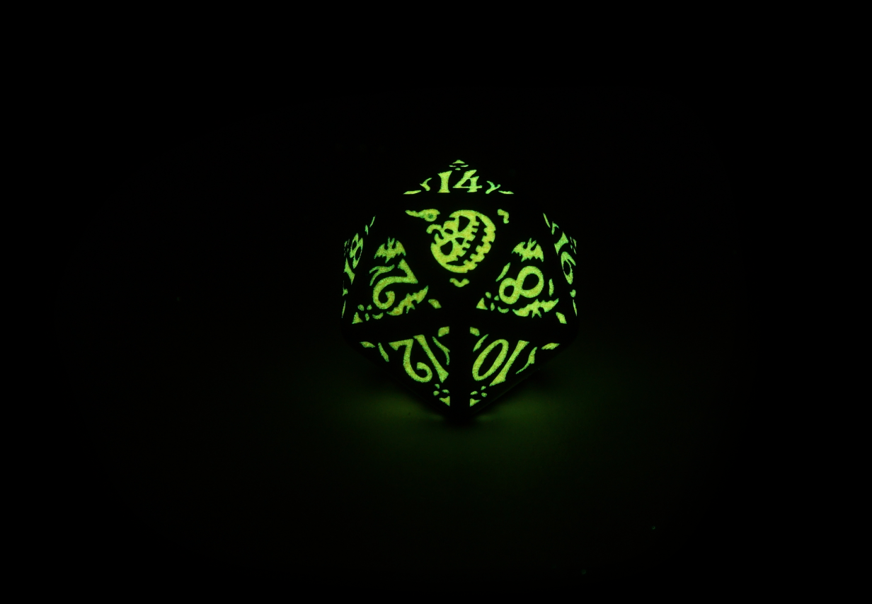 Halloween Pumpkin Dice Set D20 close up glowing green in the dark