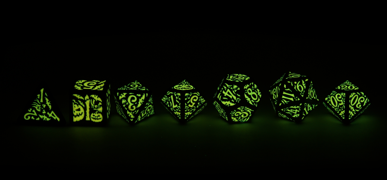 Halloween Pumpkin Dice full line up glowing green in the dark