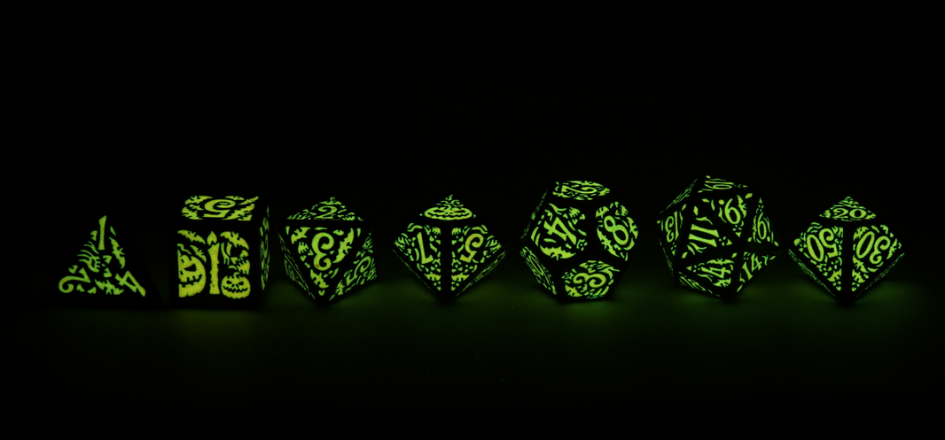 Halloween Pumpkin Dice full line up glowing green in the dark