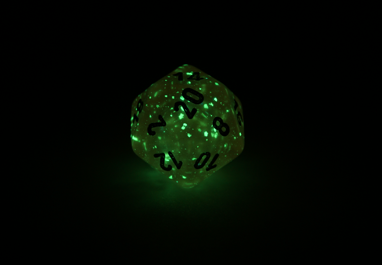 Chessex Borealis | Pink dice with silver ink that glow in the dark d20 close up glowing in the dark