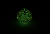 Chessex Borealis | Pink dice with silver ink that glow in the dark d20 close up glowing in the dark