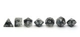 Snowstorm Dice - black and grey translucent cloudy dice with silver numbers lined up
